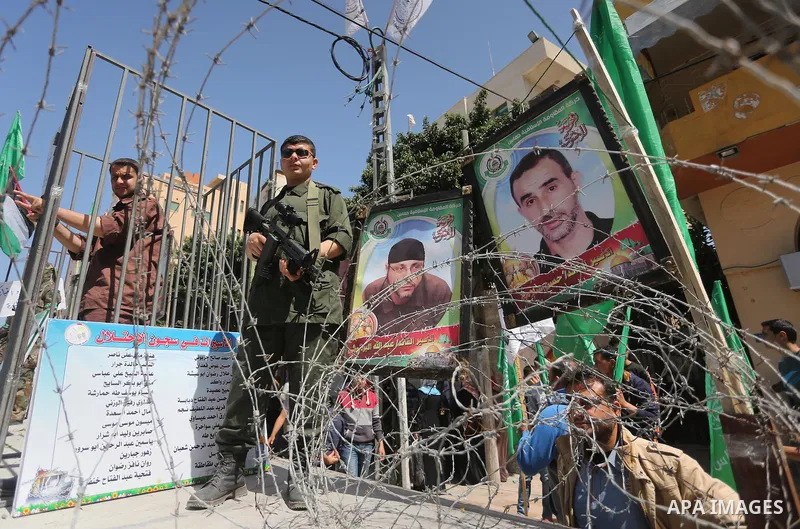 Members of the Ezzedine al-Qassam Brigades, the military wing of the Palestinian Islamist movement Hamas, stand next to mock jails during a rally marking Palestinian Prisoner Day in Gaza City on April 17, 2016. Photo by...