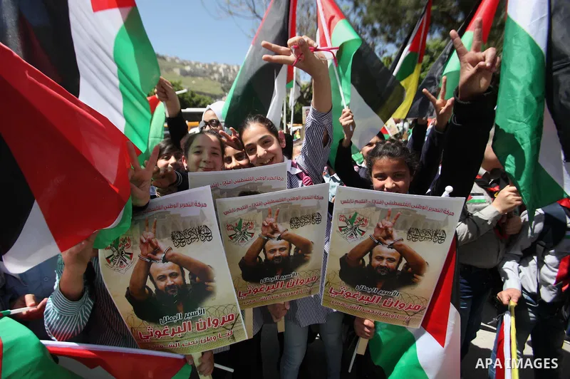 Palestinians hold pictures of Palestinians detained in Israeli prisons during a demonstration to mark Palestinian Prisoner Day in the West Bank city of Nablus on April 17, 2016. Photo by Nedal Eshtayah