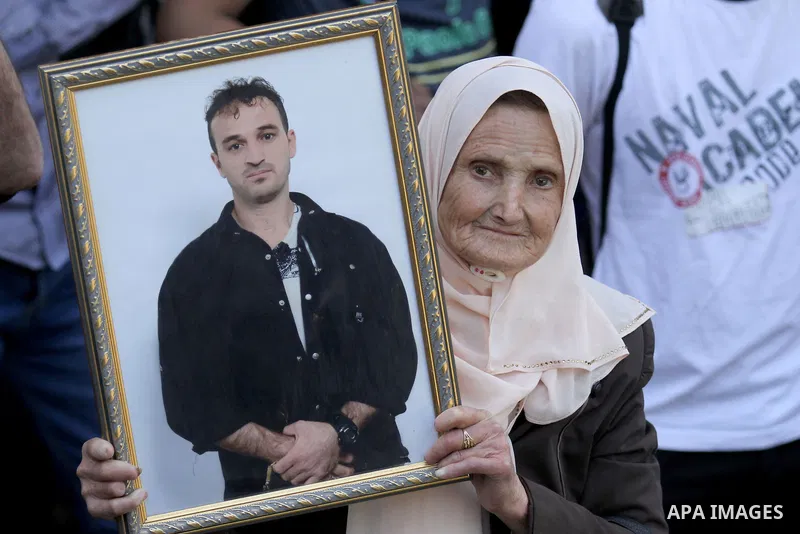 Palestinians hold pictures of Palestinians detained in Israeli prisons during a demonstration to mark Palestinian Prisoner Day in the West Bank city of Nablus on April 17, 2016. Photo by Nedal Eshtayah