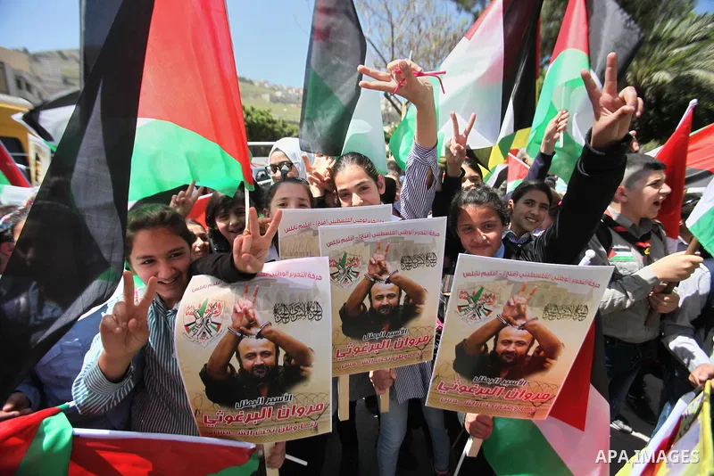 Palestinians hold pictures of Palestinians detained in Israeli prisons during a demonstration to mark Palestinian Prisoner Day in the West Bank city of Nablus on April 17, 2016. Photo by Nedal Eshtayah