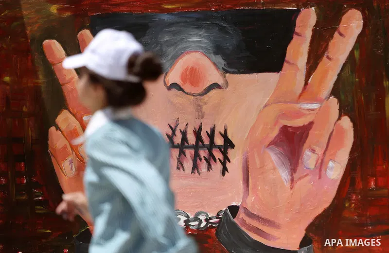 A Palestinian artist paints graffiti at school to mark Palestinian Prisoner Day in the West Bank city of Ramallah on April 17, 2016. Photo by Shadi Hatem