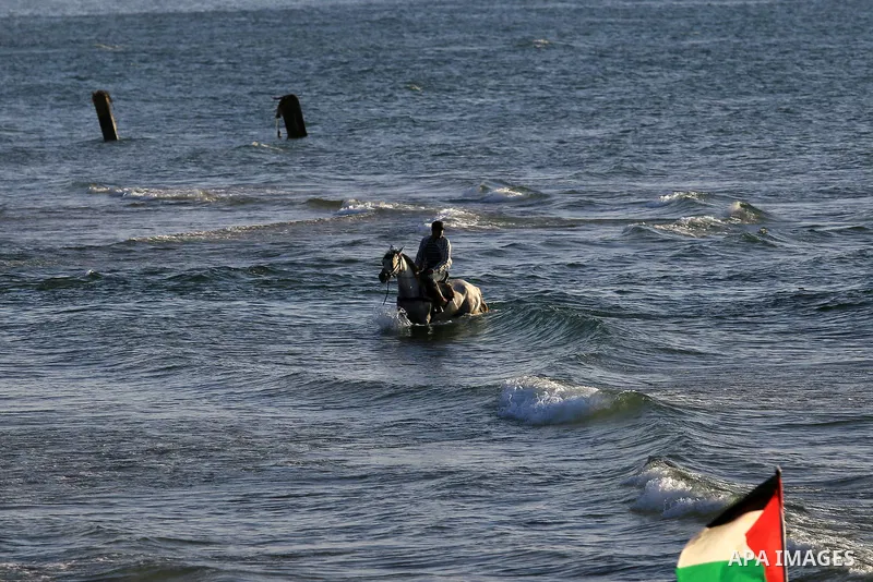 A Palestinian man rides a horse during sunset at the beach of the Mediterranean sea on the coast of Gaza city on April 17, 2016. Photo by Yasser Qudih
