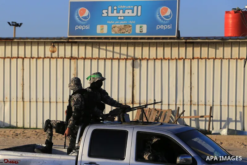 Members of the Ezzedine al-Qassam Brigades, the military wing of the Palestinian Islamist movement Hamas patrol during sunset at the beach of the Mediterranean sea on the coast of Gaza city on April 17, 2016. Photo by Ya...