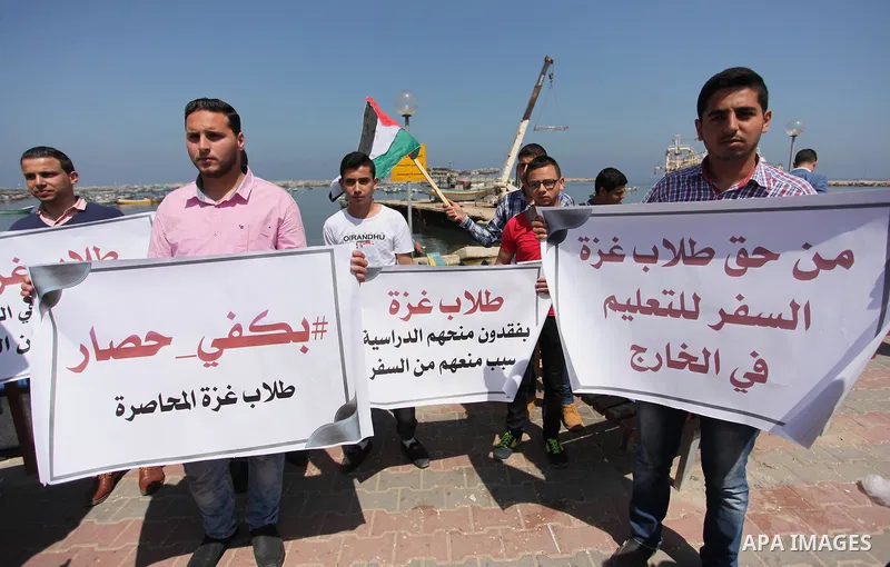 Palestinian students banned from traveling take part in a protest to demand the establishment of a seaport and to allow them to travel to complete their studies at Gaza's seaport of Gaza City, on April 18, 2016. Photo by...