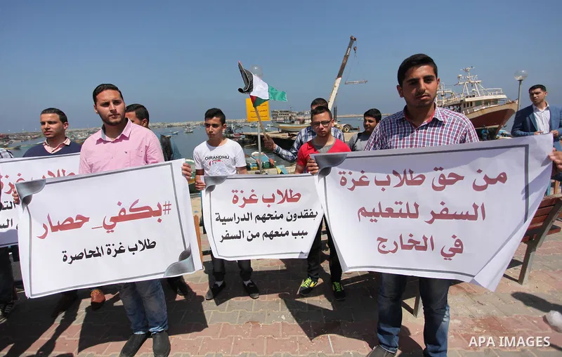 Palestinian students banned from traveling take part in a protest to demand the establishment of a seaport and to allow them to travel to complete their studies at Gaza's seaport of Gaza City, on April 18, 2016. Photo by...
