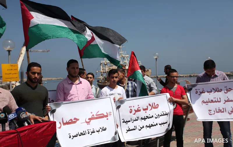 Palestinian students banned from traveling take part in a protest to demand the establishment of a seaport and to allow them to travel to complete their studies at Gaza's seaport of Gaza City, on April 18, 2016. Photo by...