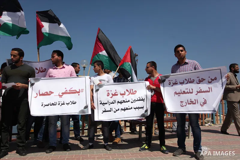 Palestinian students banned from traveling take part in a protest to demand the establishment of a seaport and to allow them to travel to complete their studies at Gaza's seaport of Gaza City, on April 18, 2016. Photo by...