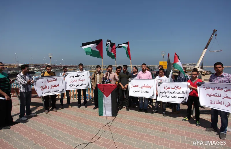 Palestinian students banned from traveling take part in a protest to demand the establishment of a seaport and to allow them to travel to complete their studies at Gaza's seaport of Gaza City, on April 18, 2016. Photo by...