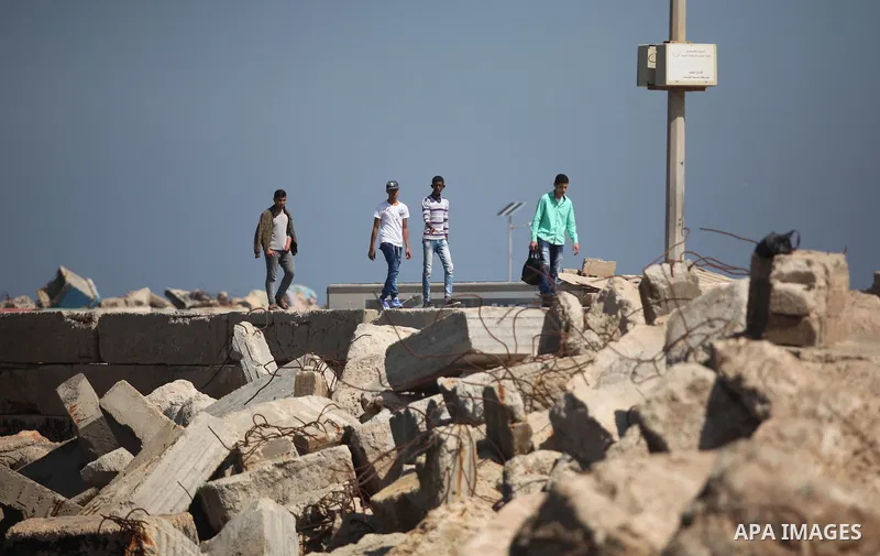 Palestinian students banned from traveling take part in a protest to demand the establishment of a seaport and to allow them to travel to complete their studies at Gaza's seaport of Gaza City, on April 18, 2016. Photo by...