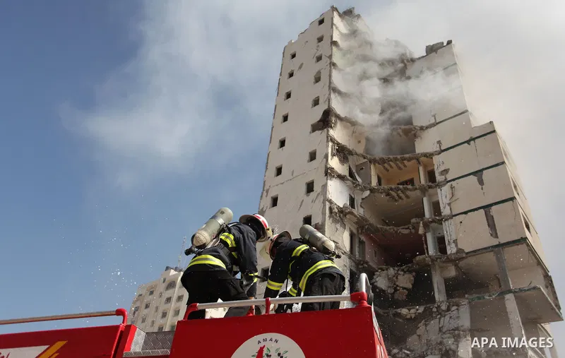 Palestinian emergency personnel take part in a drill in a building which was destroyed during the 50-day war between Israel and Hamas militants in the summer of 2014, in Gaza City, on April 19, 2016. Photo by Ashraf Amra