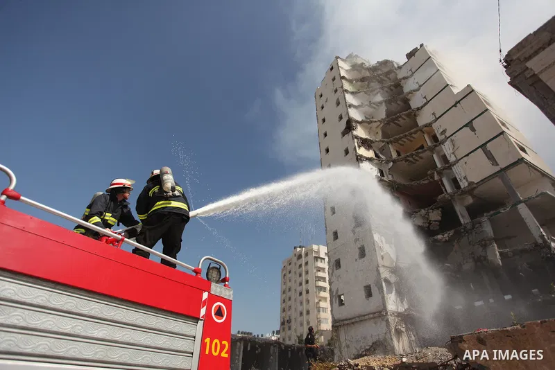 Palestinian emergency personnel take part in a drill in a building which was destroyed during the 50-day war between Israel and Hamas militants in the summer of 2014, in Gaza City, on April 19, 2016. Photo by Ashraf Amra