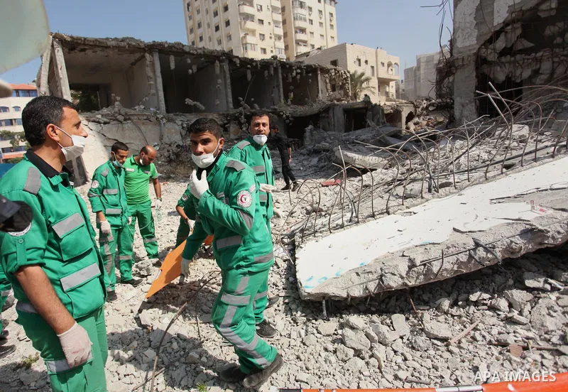 Palestinian emergency personnel take part in a drill in a building which was destroyed during the 50-day war between Israel and Hamas militants in the summer of 2014, in Gaza City, on April 19, 2016. Photo by Ashraf Amra