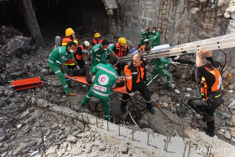 Palestinian emergency personnel take part in a drill in a building which was destroyed during the 50-day war between Israel and Hamas militants in the summer of 2014, in Gaza City, on April 19, 2016. Photo by Ashraf Amra