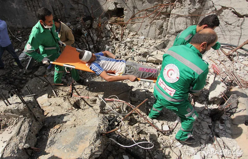 Palestinian emergency personnel take part in a drill in a building which was destroyed during the 50-day war between Israel and Hamas militants in the summer of 2014, in Gaza City, on April 19, 2016. Photo by Ashraf Amra