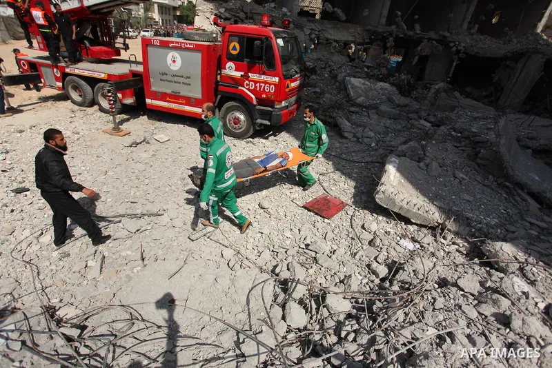 Palestinian emergency personnel take part in a drill in a building which was destroyed during the 50-day war between Israel and Hamas militants in the summer of 2014, in Gaza City, on April 19, 2016. Photo by Ashraf Amra