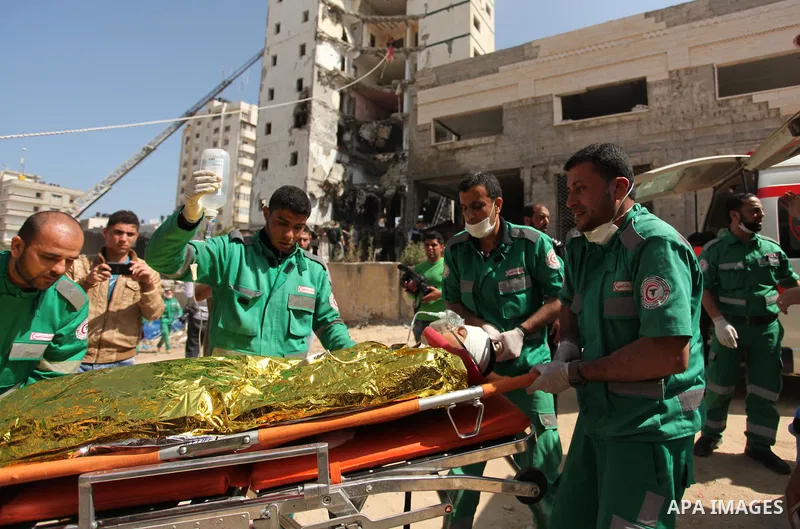 Palestinian emergency personnel take part in a drill in a building which was destroyed during the 50-day war between Israel and Hamas militants in the summer of 2014, in Gaza City, on April 19, 2016. Photo by Ashraf Amra