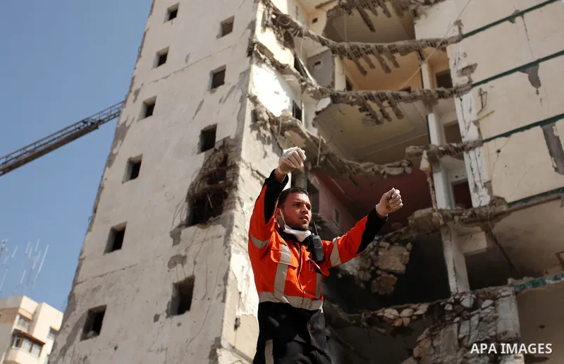 Palestinian emergency personnel take part in a drill in a building which was destroyed during the 50-day war between Israel and Hamas militants in the summer of 2014, in Gaza City, on April 19, 2016. Photo by Ashraf Amra