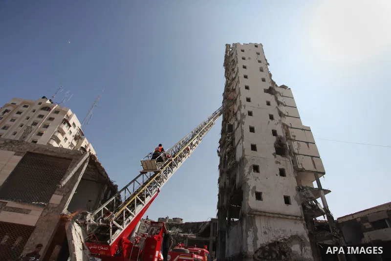 Palestinian emergency personnel take part in a drill in a building which was destroyed during the 50-day war between Israel and Hamas militants in the summer of 2014, in Gaza City, on April 19, 2016. Photo by Ashraf Amra