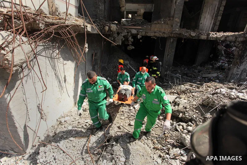 Palestinian emergency personnel take part in a drill in a building which was destroyed during the 50-day war between Israel and Hamas militants in the summer of 2014, in Gaza City, on April 19, 2016. Photo by Ashraf Amra