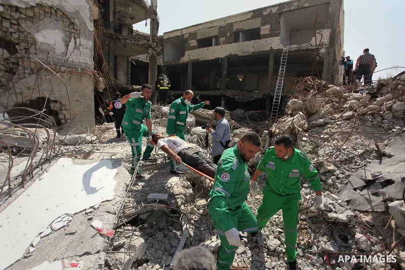 Palestinian emergency personnel take part in a drill in a building which was destroyed during the 50-day war between Israel and Hamas militants in the summer of 2014, in Gaza City, on April 19, 2016. Photo by Ashraf Amra