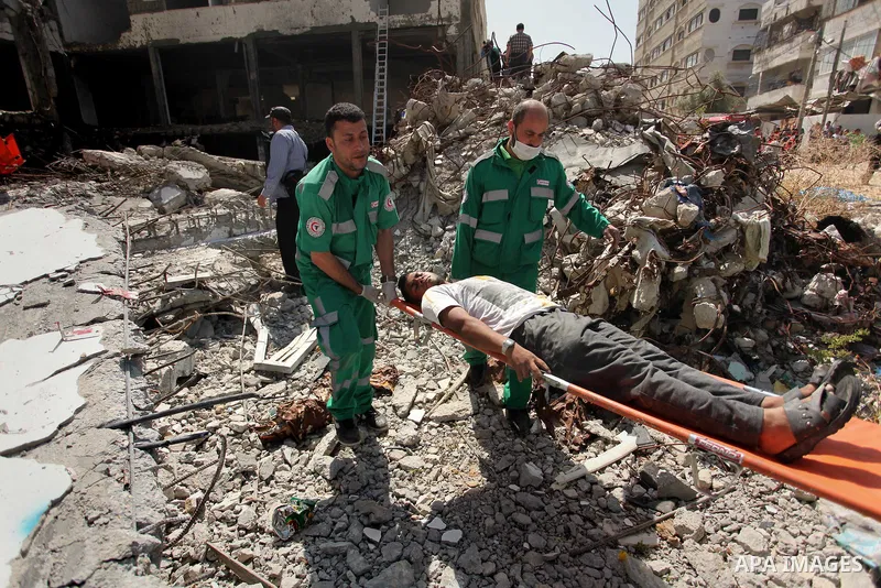 Palestinian emergency personnel take part in a drill in a building which was destroyed during the 50-day war between Israel and Hamas militants in the summer of 2014, in Gaza City, on April 19, 2016. Photo by Ashraf Amra