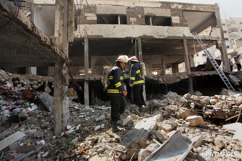 Palestinian emergency personnel take part in a drill in a building which was destroyed during the 50-day war between Israel and Hamas militants in the summer of 2014, in Gaza City, on April 19, 2016. Photo by Ashraf Amra