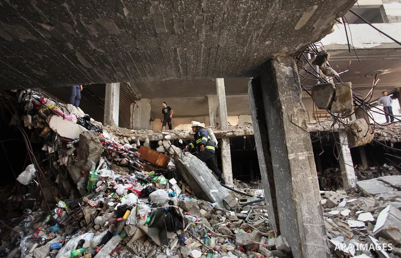 Palestinian emergency personnel take part in a drill in a building which was destroyed during the 50-day war between Israel and Hamas militants in the summer of 2014, in Gaza City, on April 19, 2016. Photo by Ashraf Amra