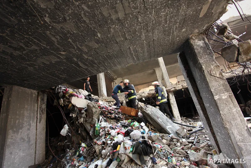 Palestinian emergency personnel take part in a drill in a building which was destroyed during the 50-day war between Israel and Hamas militants in the summer of 2014, in Gaza City, on April 19, 2016. Photo by Ashraf Amra