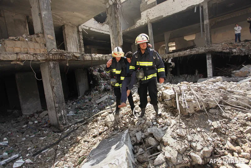Palestinian emergency personnel take part in a drill in a building which was destroyed during the 50-day war between Israel and Hamas militants in the summer of 2014, in Gaza City, on April 19, 2016. Photo by Ashraf Amra