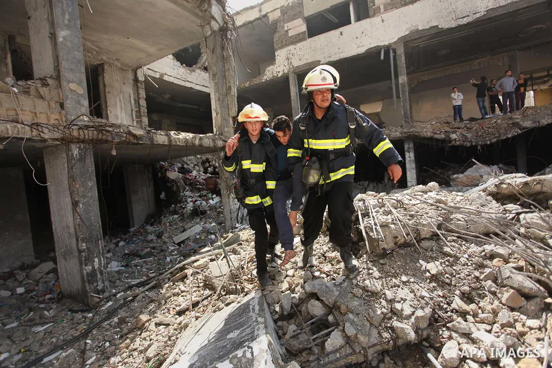 Palestinian emergency personnel take part in a drill in a building which was destroyed during the 50-day war between Israel and Hamas militants in the summer of 2014, in Gaza City, on April 19, 2016. Photo by Ashraf Amra
