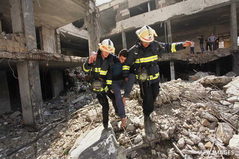 Palestinian emergency personnel take part in a drill in a building which was destroyed during the 50-day war between Israel and Hamas militants in the summer of 2014, in Gaza City, on April 19, 2016. Photo by Ashraf Amra