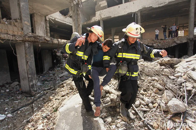 Palestinian emergency personnel take part in a drill in a building which was destroyed during the 50-day war between Israel and Hamas militants in the summer of 2014, in Gaza City, on April 19, 2016. Photo by Ashraf Amra