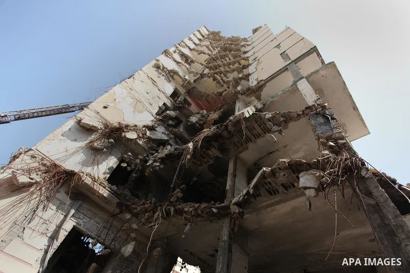 Palestinian emergency personnel take part in a drill in a building which was destroyed during the 50-day war between Israel and Hamas militants in the summer of 2014, in Gaza City, on April 19, 2016. Photo by Ashraf Amra