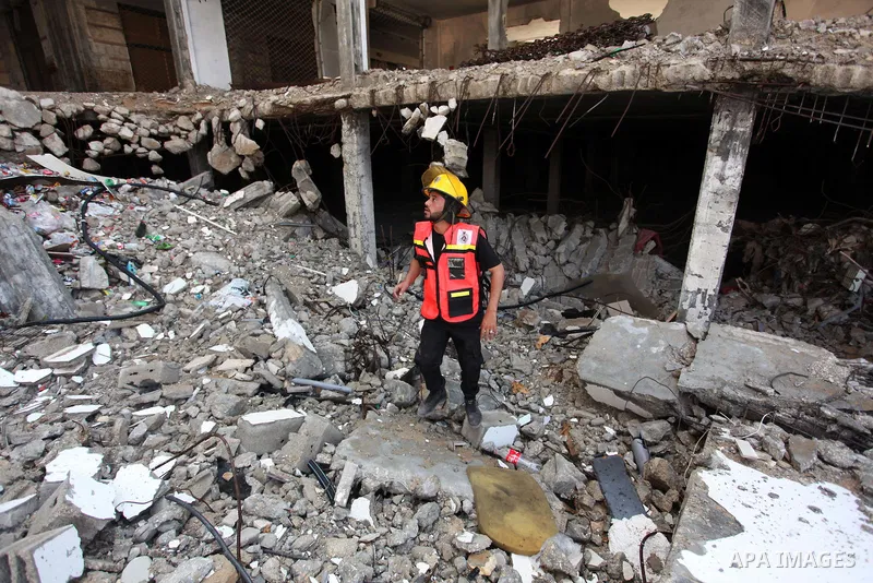 Palestinian emergency personnel take part in a drill in a building which was destroyed during the 50-day war between Israel and Hamas militants in the summer of 2014, in Gaza City, on April 19, 2016. Photo by Ashraf Amra