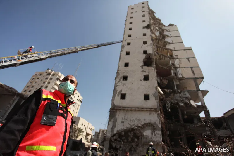 Palestinian emergency personnel take part in a drill in a building which was destroyed during the 50-day war between Israel and Hamas militants in the summer of 2014, in Gaza City, on April 19, 2016. Photo by Ashraf Amra
