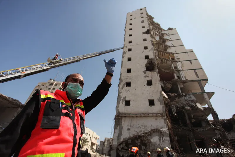 Palestinian emergency personnel take part in a drill in a building which was destroyed during the 50-day war between Israel and Hamas militants in the summer of 2014, in Gaza City, on April 19, 2016. Photo by Ashraf Amra