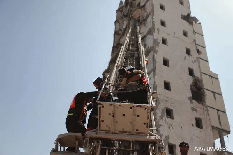 Palestinian emergency personnel take part in a drill in a building which was destroyed during the 50-day war between Israel and Hamas militants in the summer of 2014, in Gaza City, on April 19, 2016. Photo by Ashraf Amra