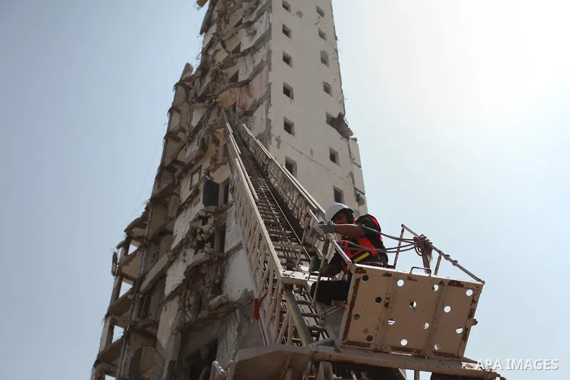 Palestinian emergency personnel take part in a drill in a building which was destroyed during the 50-day war between Israel and Hamas militants in the summer of 2014, in Gaza City, on April 19, 2016. Photo by Ashraf Amra