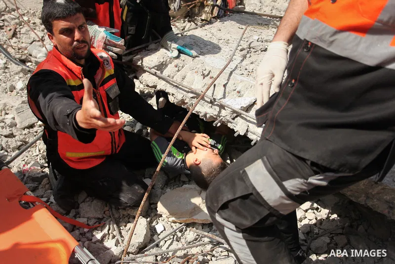 Palestinian emergency personnel take part in a drill in a building which was destroyed during the 50-day war between Israel and Hamas militants in the summer of 2014, in Gaza City, on April 19, 2016. Photo by Ashraf Amra