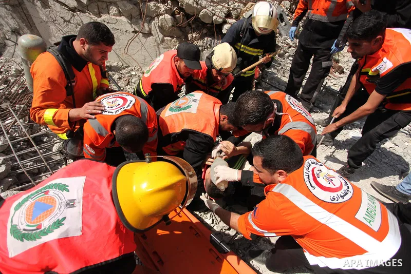 Palestinian emergency personnel take part in a drill in a building which was destroyed during the 50-day war between Israel and Hamas militants in the summer of 2014, in Gaza City, on April 19, 2016. Photo by Ashraf Amra
