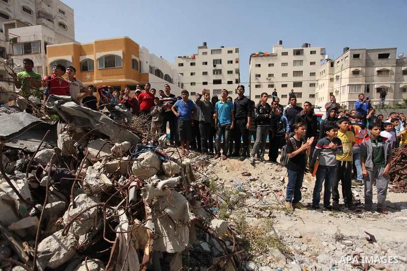 Palestinian emergency personnel take part in a drill in a building which was destroyed during the 50-day war between Israel and Hamas militants in the summer of 2014, in Gaza City, on April 19, 2016. Photo by Ashraf Amra