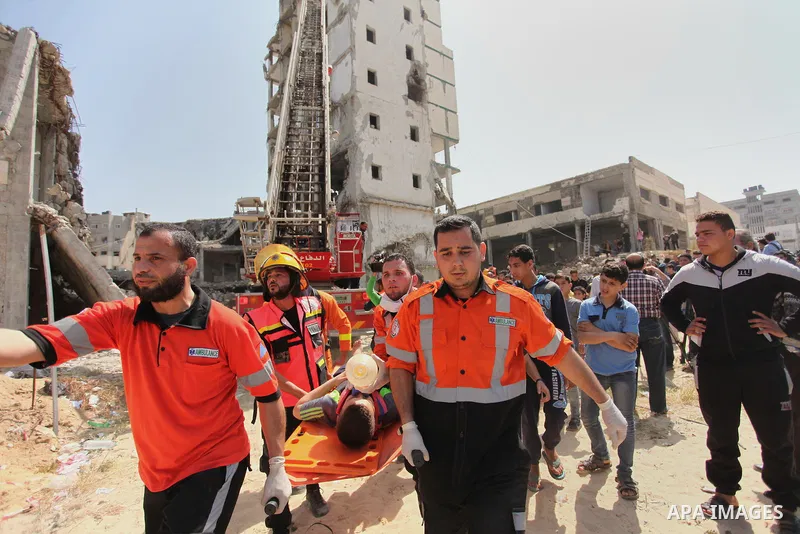 Palestinian emergency personnel take part in a drill in a building which was destroyed during the 50-day war between Israel and Hamas militants in the summer of 2014, in Gaza City, on April 19, 2016. Photo by Ashraf Amra