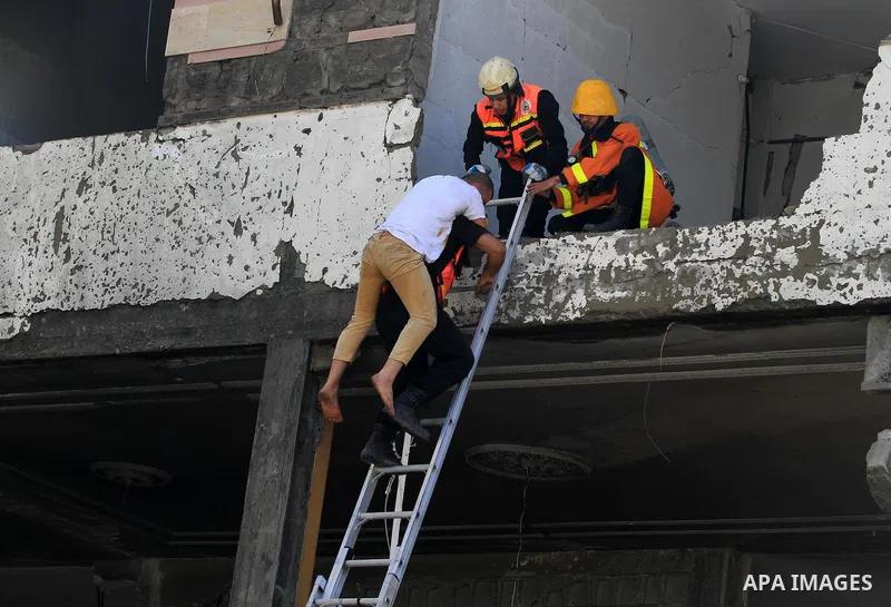 Palestinian emergency personnel take part in a drill in a building which was destroyed during the 50-day war between Israel and Hamas militants in the summer of 2014, in Gaza City, on April 19, 2016. Photo by Ashraf Amra