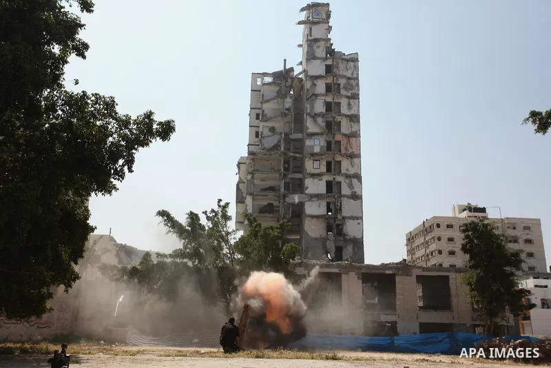 Palestinian emergency personnel take part in a drill in a building which was destroyed during the 50-day war between Israel and Hamas militants in the summer of 2014, in Gaza City, on April 19, 2016. Photo by Ashraf Amra