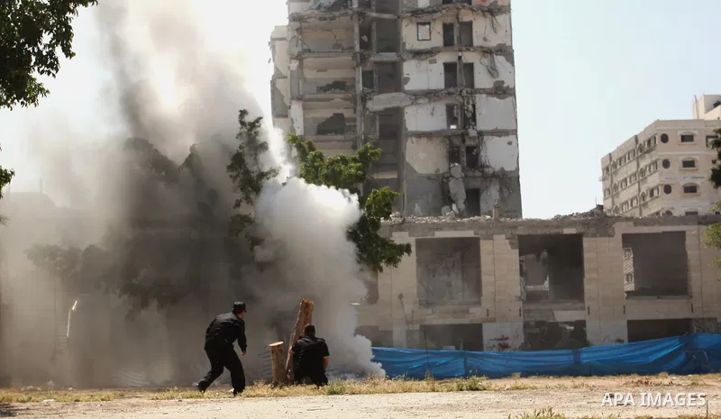 Palestinian emergency personnel take part in a drill in a building which was destroyed during the 50-day war between Israel and Hamas militants in the summer of 2014, in Gaza City, on April 19, 2016. Photo by Ashraf Amra
