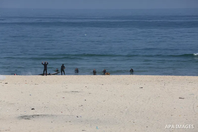 Palestinian emergency personnel take part in a drill ,at the beach of the Mediterranean sea on the coast of Gaza city, on April 19, 2016. Photo by Mohammed Asad