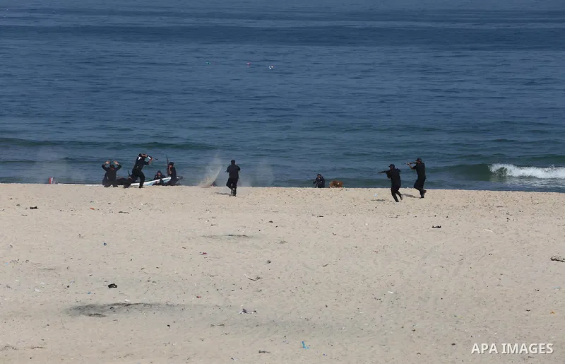 Palestinian emergency personnel take part in a drill ,at the beach of the Mediterranean sea on the coast of Gaza city, on April 19, 2016. Photo by Mohammed Asad