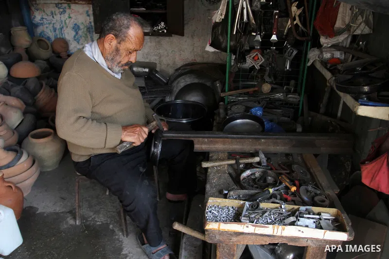 A Palestinian man works at his work-shop in a market in Rafah in the southern Gaza strip, April 19, 2016. Photo by Abed Rahim Khatib