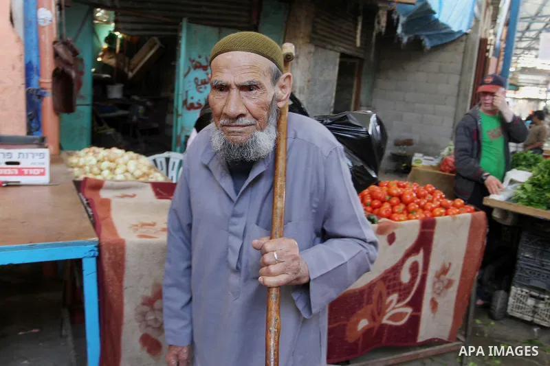 A Palestinian man walks at market in Rafah in the southern Gaza Strip, April 19, 2016. Photo by Abed Rahim Khatib
