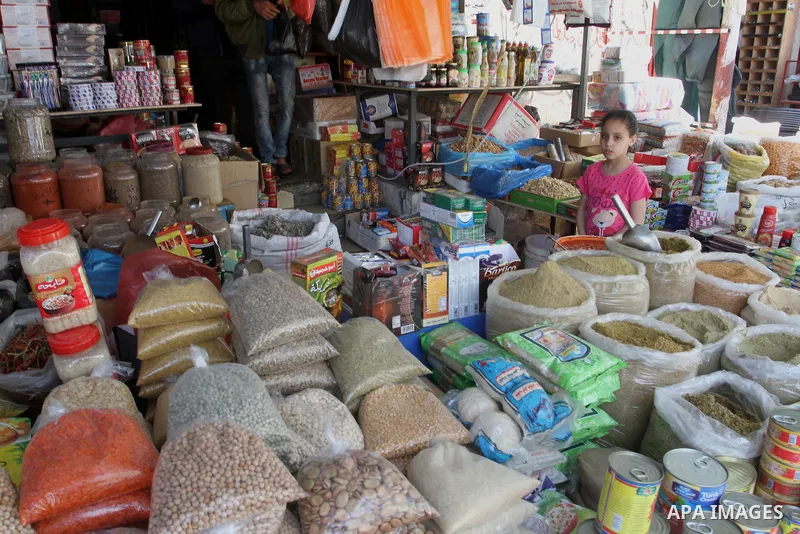 A Palestinian man sells goods at his shop in a market in Rafah in the southern Gaza Strip, April 19, 2016. Photo by Abed Rahim Khatib